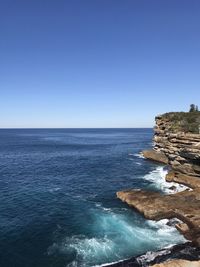 Scenic view of sea against clear blue sky