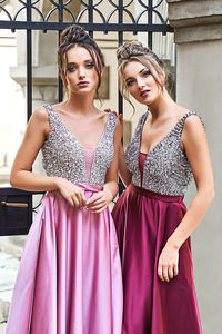 Young woman standing against wall