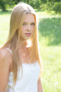 Portrait of blond teenage girl at park