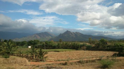 Scenic view of mountains against cloudy sky