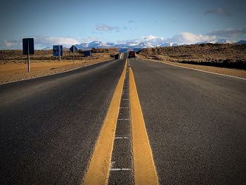 Surface level of empty road against sky