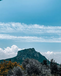 Scenic view of mountains against blue sky