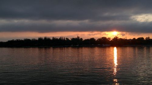 Scenic view of lake against sky during sunset