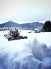 Vintage car on snow covered mountains against sky