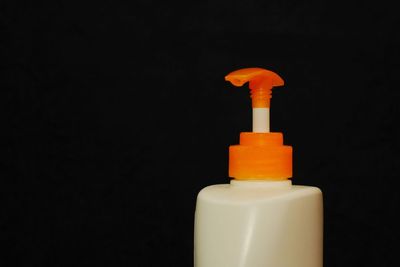 Close-up of bottle against black background