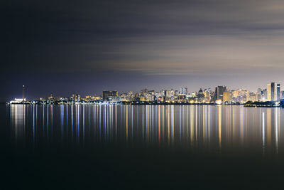 Cityscape by the river at night.