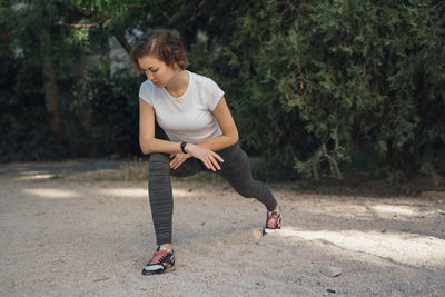 Full length of young woman looking away