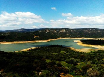 Scenic view of lake against cloudy sky