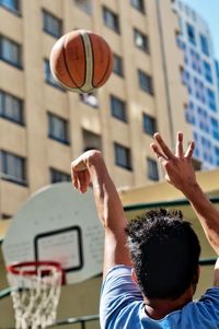 Low angle view of people playing basketball