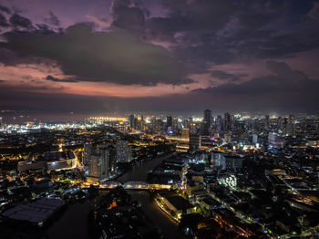 High angle view of illuminated cityscape against sky during sunset