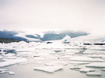 Close-up of frozen landscape against sky