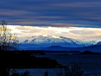 Scenic view of snowcapped mountains against sky during sunset