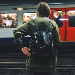 Rear view of woman sitting at night