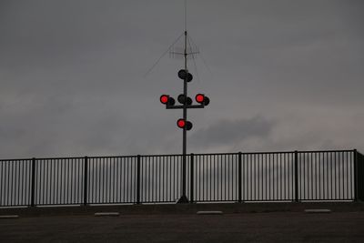 Boat/street light against sky at sea