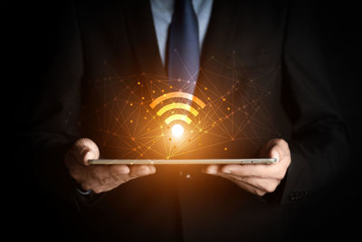 Close-up of hand holding illuminated lighting equipment