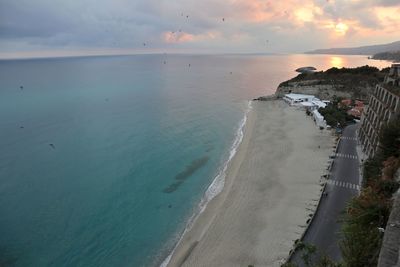 High angle view of beach against sky during sunset