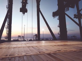 Silhouette pier by sea against sky during sunset