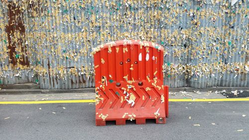 Red barricade on street against metallic wall