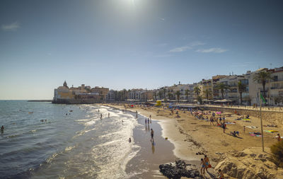 View of beach by buildings against sky