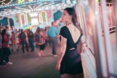 Young woman standing at music concert