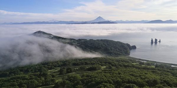 Scenic view of viluchinskii volcano, avacha bay and rocks three brothers. russia,kamchatka peninsula