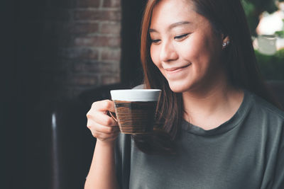 Smiling woman holding coffee cup