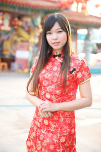 Portrait of a smiling young woman standing outdoors