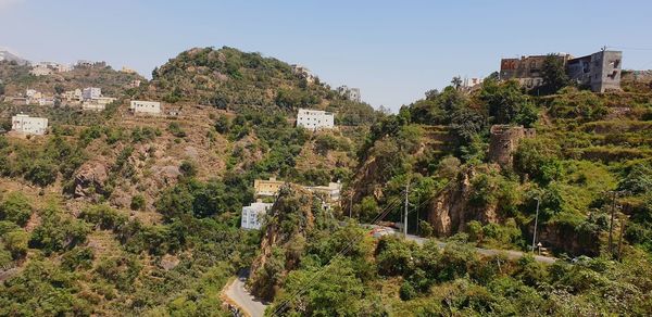 Panoramic view of trees and buildings against clear sky