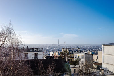 High angle view of townscape by sea against sky