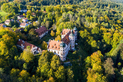 High angle view of trees and houses in village during autumn