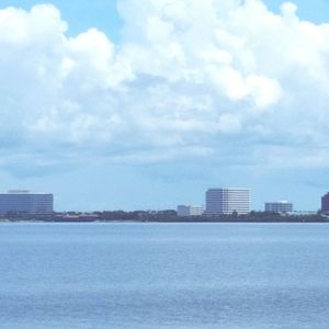 Buildings in city against cloudy sky