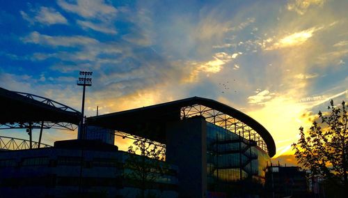 Low angle view of building against sky at sunset