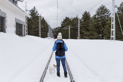 Rear view of person on snow covered land