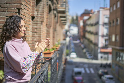 Woman sitting in front of buildings