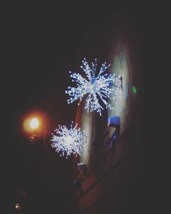 Low angle view of firework display at night