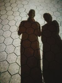 Shadow of children on cobblestone