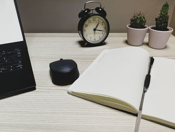 High angle view of laptop and book on table