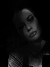 Portrait of beautiful young woman in darkroom