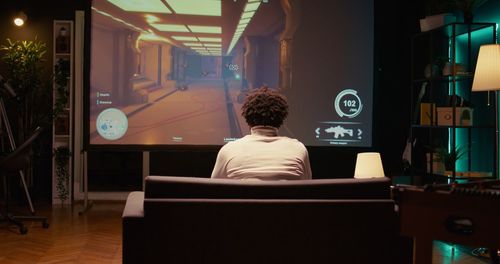 Rear view of woman using laptop on table