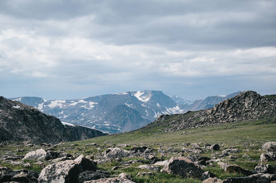 Scenic view of mountains against cloudy sky