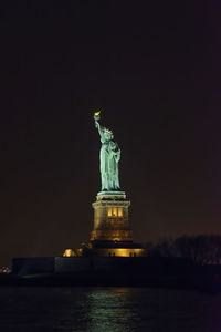 Statue of liberty against sky at night