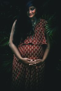 Beautiful woman standing with arms raised