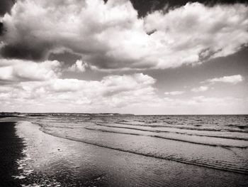 Scenic view of sea against cloudy sky