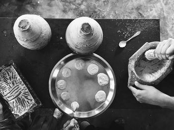 Cropped image of people preparing food on table