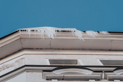 Icicles hanging from the edge of roof