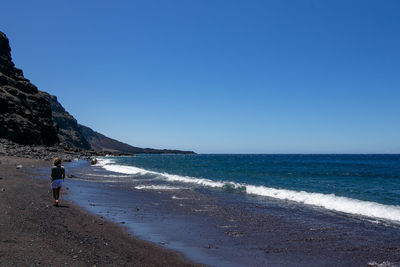 Scenic view of sea against clear blue sky