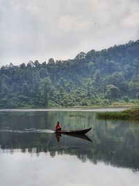 Boat on lake against sky