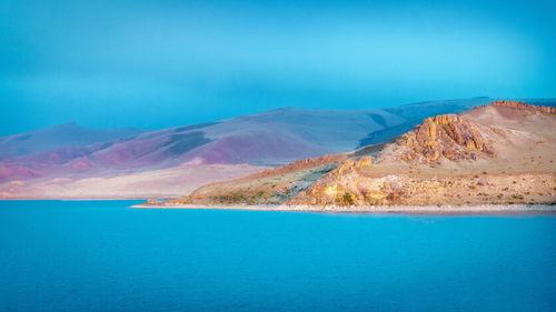 Scenic view of sea against clear blue sky