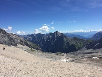 Scenic view of mountains against blue sky
