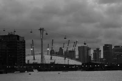 View of cityscape against cloudy sky